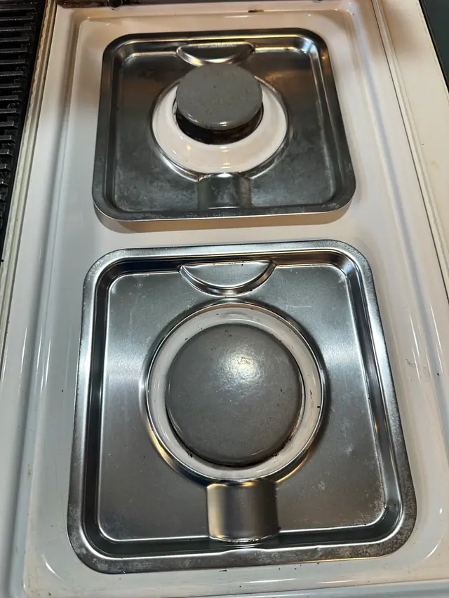 After: a gas stovetop wiped back to clean stainless